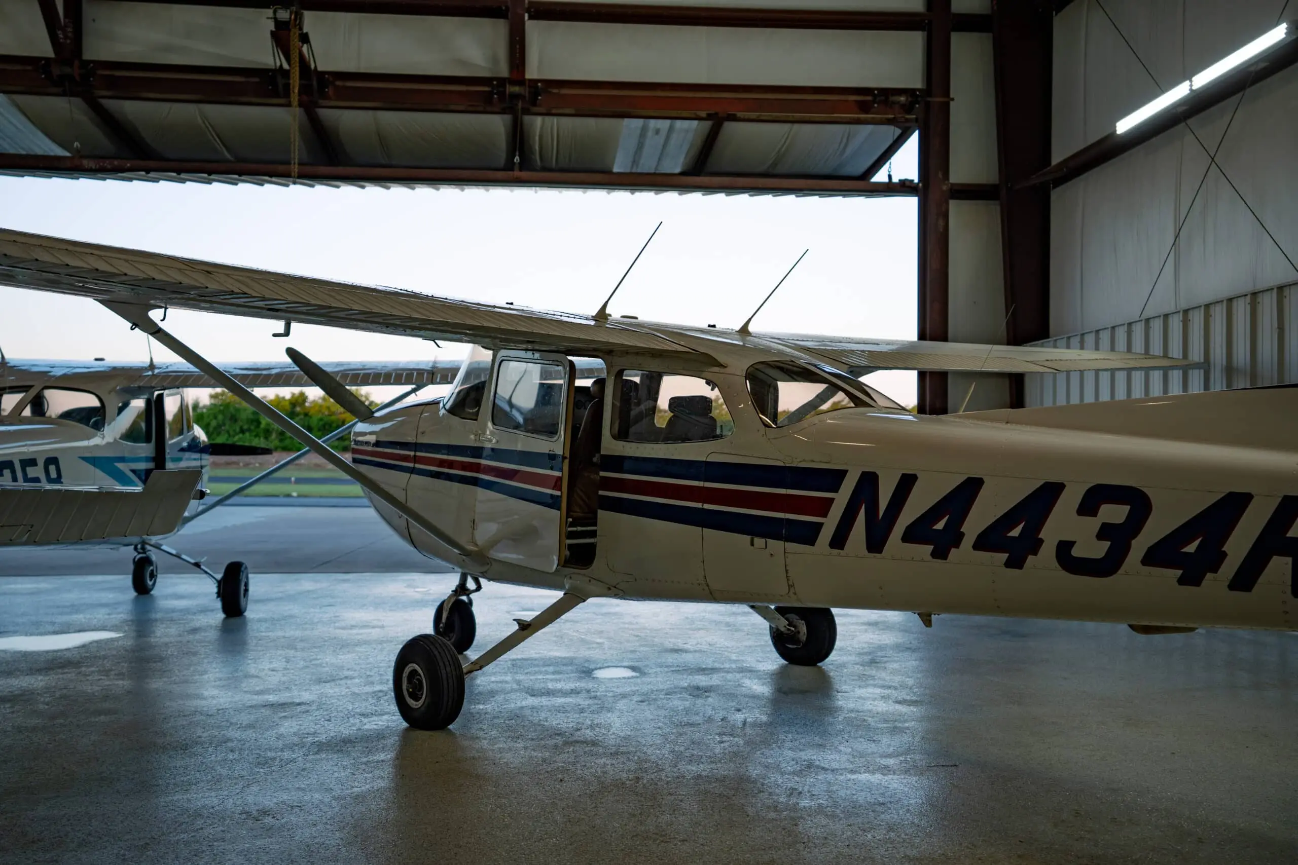 A pilot engaging with advanced avionics in a meticulously maintained training cockpit