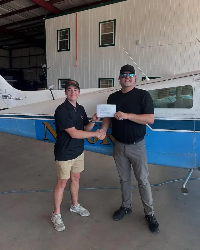 Student pilot celebrating passing checkride at Bird Dog Flight Services