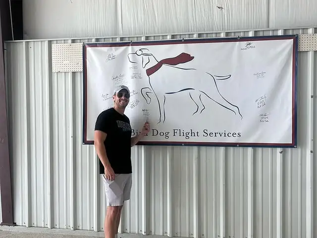 Successful PPL student signing the solo wall at Texas flight school